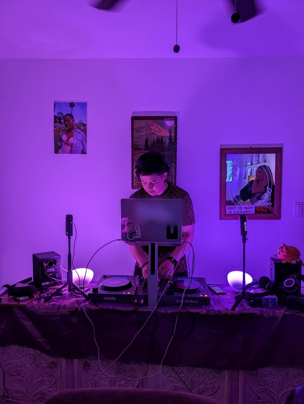 A DJ playing a set in the purple-lit Honeybun studio